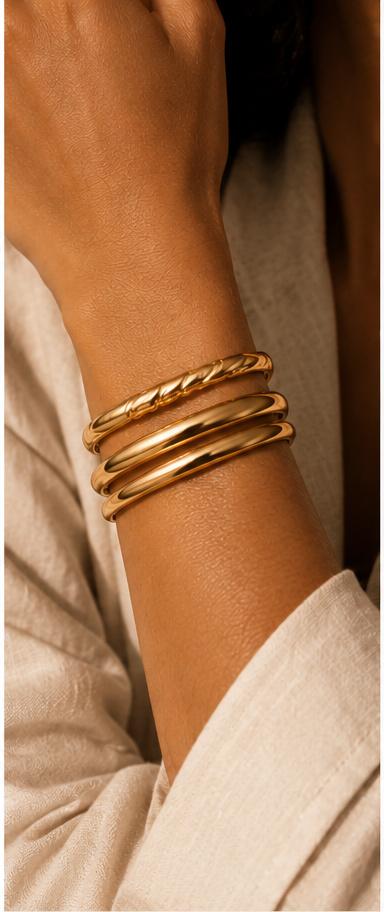 Gold bracelets worn on a wrist