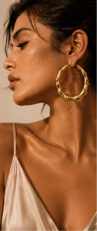 Woman wearing gold bamboo hoop earrings