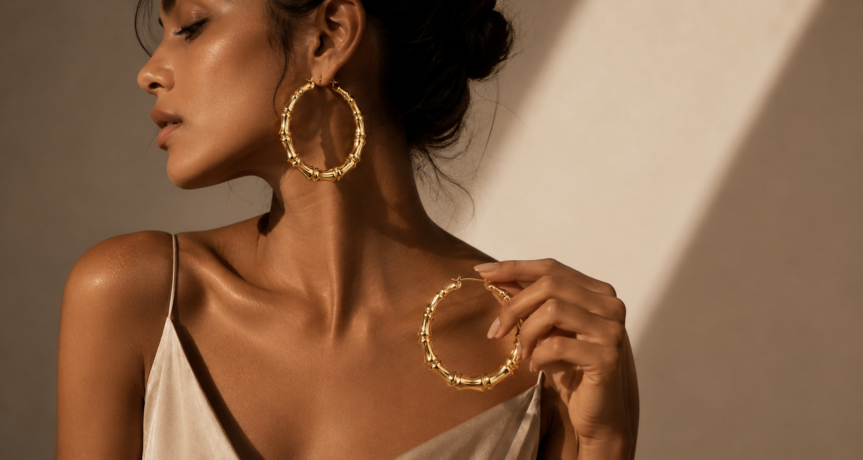 ZERVALIS woman wearing gold bamboo hoop earrings